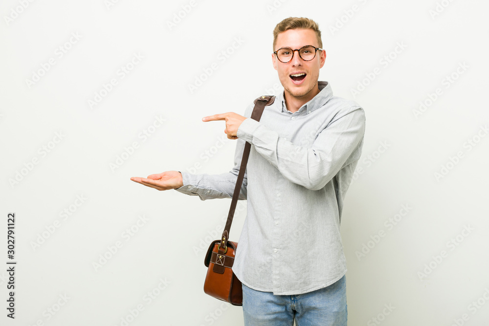 Young caucasian business man excited holding a copy space on palm. Young caucasian business man excited holding a copy space on palm.