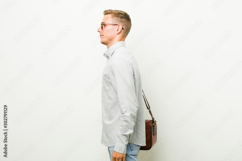 Young caucasian business man gazing left, sideways pose. Young caucasian business man gazing left, sideways pose.