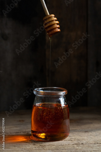 honey cake. jar of honey. hand with a spoon for honey. honey drips from a spoon