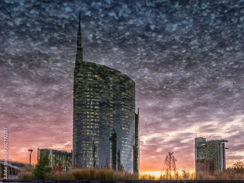 View of the towers of Milan Porta Nuova reflected in the water, at sunset. photo