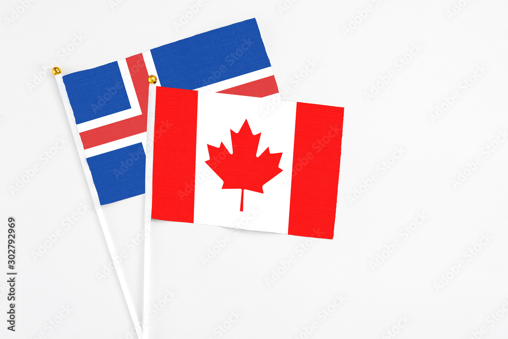 Canada and Iceland stick flags on white background. High quality fabric, miniature national flag. Peaceful global concept.White floor for copy space. Canada and Iceland stick flags on white background. High quality fabric, miniature national flag. Peaceful global concept.White floor for copy space.