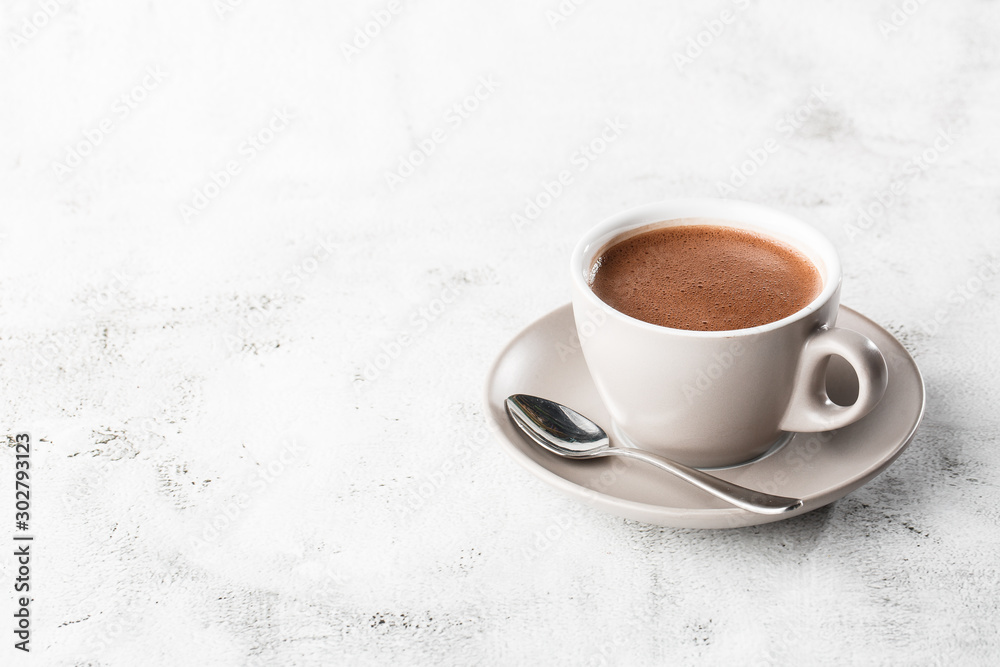 Cup of hot cocoa or hot chocolate or americano in white cup isolated on bright marble background.  Horizontal photo. traditional drinks for winter time
