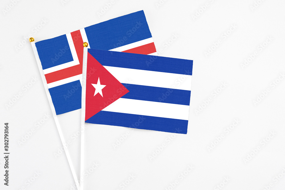 Cuba and Iceland stick flags on white background. High quality fabric, miniature national flag. Peaceful global concept.White floor for copy space. Cuba and Iceland stick flags on white background. High quality fabric, miniature national flag. Peaceful global concept.White floor for copy space.