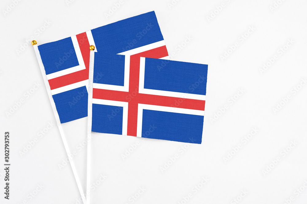 Iceland and Iceland stick flags on white background. High quality fabric, miniature national flag. Peaceful global concept.White floor for copy space. Iceland and Iceland stick flags on white background. High quality fabric, miniature national flag. Peaceful global concept.White floor for copy space.