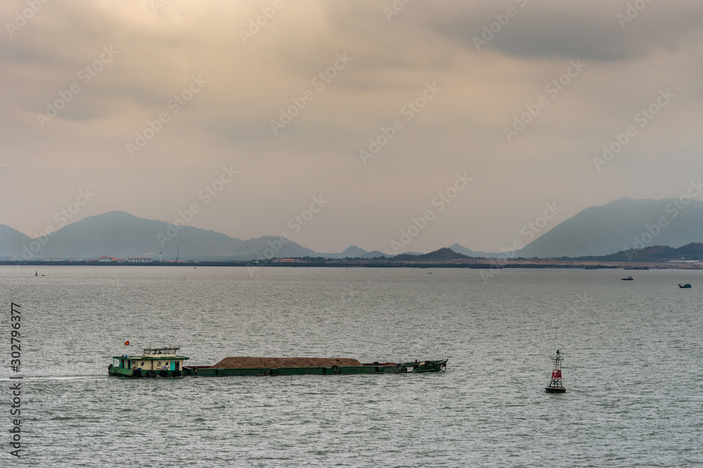 Barge with sand pushed at mouth of Long Tau River, Vung Tau city, Vietnam.