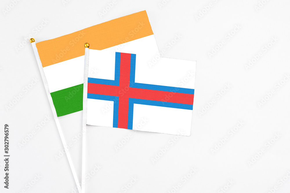 Faroe Islands and India stick flags on white background. High quality fabric, miniature national flag. Peaceful global concept.White floor for copy space.