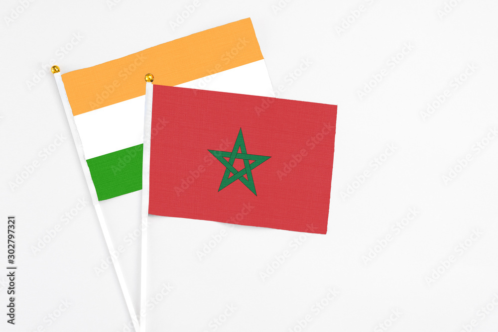 Morocco and India stick flags on white background. High quality fabric, miniature national flag. Peaceful global concept.White floor for copy space. Morocco and India stick flags on white background. High quality fabric, miniature national flag. Peaceful global concept.White floor for copy space.