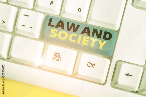 Text sign showing Law And Society. Business photo text Address the mutual relationship between law and society White pc keyboard with empty note paper above white background key copy space photo