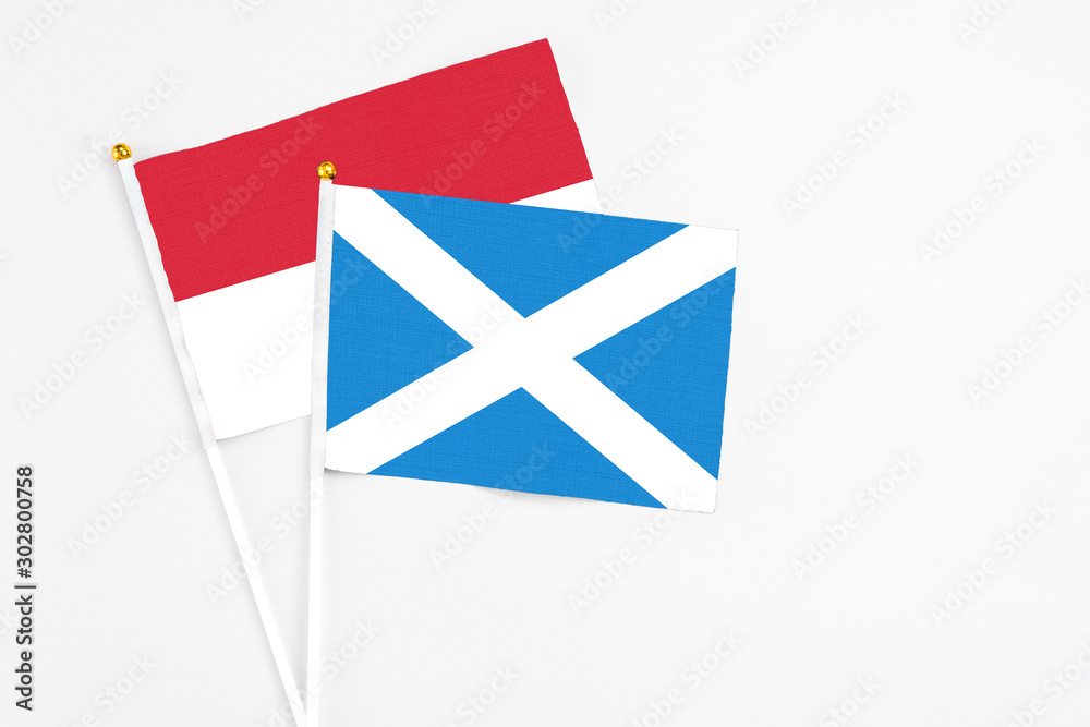 Scotland and Indonesia stick flags on white background. High quality fabric, miniature national flag. Peaceful global concept.White floor for copy space.