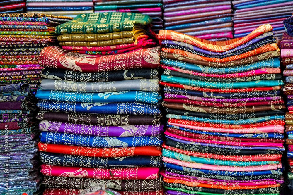 stacks of folded scarves with colorful patterns, fabric, silk, cashmere, gifts on the oriental market, purchase, texture multi-colored wallpaper stacks of folded scarves with colorful patterns, fabric, silk, cashmere, gifts on the oriental market, purchase, texture multi-colored wallpaper
