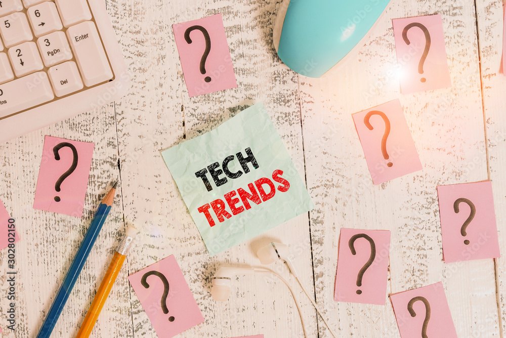 Writing note showing Tech Trends. Business concept for technology that is recently becoming popular and accepted Writing tools and scribbled paper on top of the wooden table Writing note showing Tech Trends. Business concept for technology that is recently becoming popular and accepted Writing tools and scribbled paper on top of the wooden table