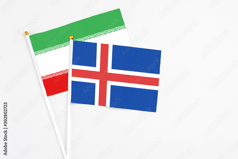 Iceland and Iran stick flags on white background. High quality fabric, miniature national flag. Peaceful global concept.White floor for copy space. Iceland and Iran stick flags on white background. High quality fabric, miniature national flag. Peaceful global concept.White floor for copy space.