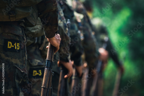 Soldiers stand in row. Gun in hand. Army, Military Boots lines of commando soldiers in camouflage uniforms Thailand