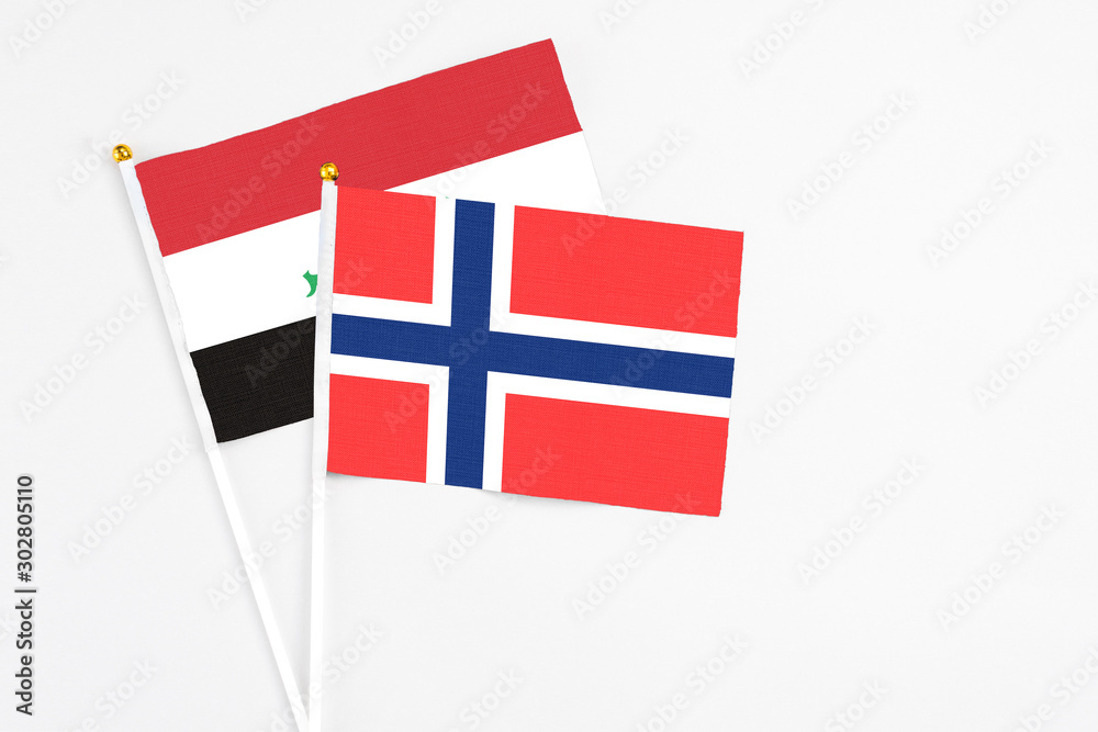 Bouvet Islands and Iraq stick flags on white background. High quality fabric, miniature national flag. Peaceful global concept.White floor for copy space.