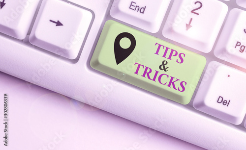 Writing note showing Tips And Tricks. Business concept for Steps Lifehacks Handy advice Recommendations Skills photo