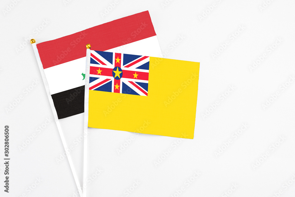 Niue and Iraq stick flags on white background. High quality fabric, miniature national flag. Peaceful global concept.White floor for copy space. Niue and Iraq stick flags on white background. High quality fabric, miniature national flag. Peaceful global concept.White floor for copy space.