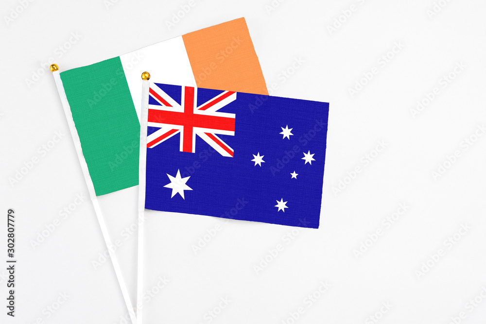 Fototapeta premium Australia and Ireland stick flags on white background. High quality fabric, miniature national flag. Peaceful global concept.White floor for copy space