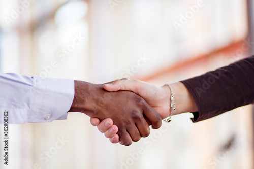 Handshake between african and a caucasian man.
