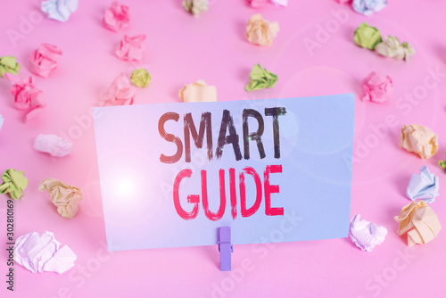 Handwriting text Smart Guide. Conceptual photo used to guide the development of measurable goals to attain Colored crumpled papers empty reminder pink floor background clothespin photo