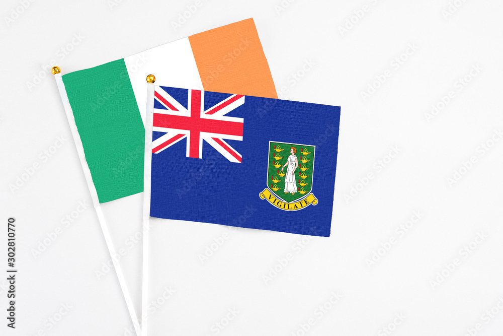 Fototapeta premium British Virgin Islands and Ireland stick flags on white background. High quality fabric, miniature national flag. Peaceful global concept.White floor for copy space