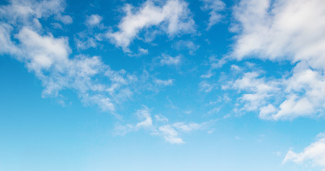 Wide panorama of beautiful blue sky with fluffy white cumulus clouds, nature background for banner and sky replacement