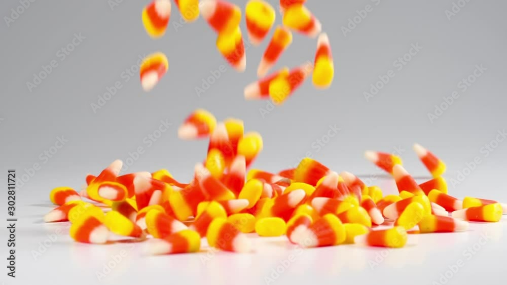 Time for Halloween. Delicious candy corn falls in slow motion.
