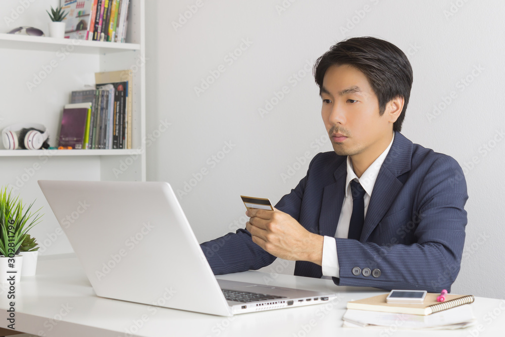 Asian Businessman Shopping Online by Use Credit Card Asian Businessman Shopping Online by Use Credit Card