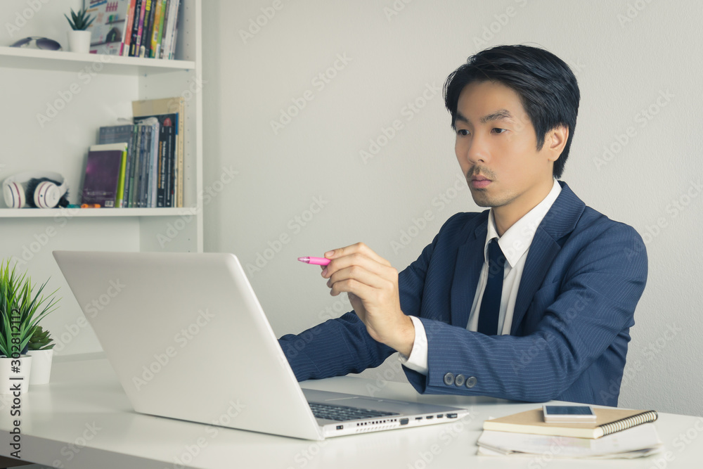 Asian Financial Advisor or Asian Consulting Businessman Suggest Customer Via Internet in Vintage Tone Asian Financial Advisor or Asian Consulting Businessman Suggest Customer Via Internet in Vintage Tone
