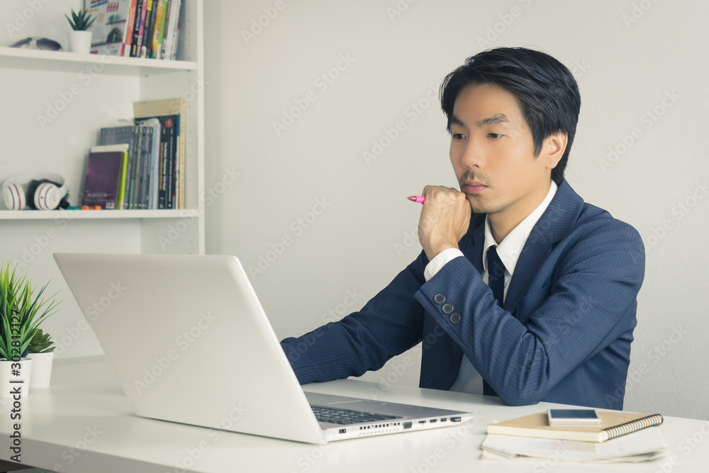 Asian Financial Advisor or Asian Consulting Businessman Thinking and Calculate in Vintage Tone Asian Financial Advisor or Asian Consulting Businessman Thinking and Calculate in Vintage Tone