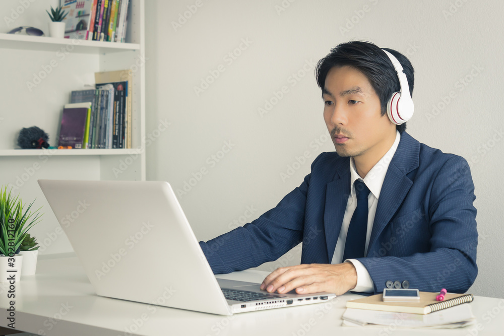 Asian Man Call Center Wear Headset Service Customer Via Internet in Vintage Tone Asian Man Call Center Wear Headset Service Customer Via Internet in Vintage Tone
