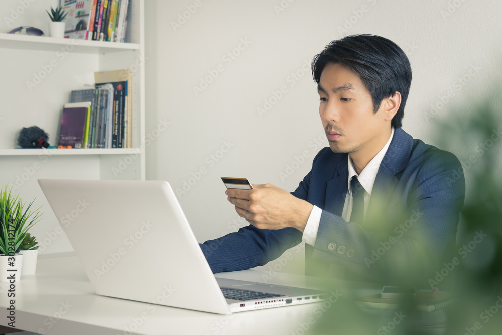 Asian Businessman Fill Credit Card Information for Online Shopping in Vintage Tone Asian Businessman Fill Credit Card Information for Online Shopping in Vintage Tone