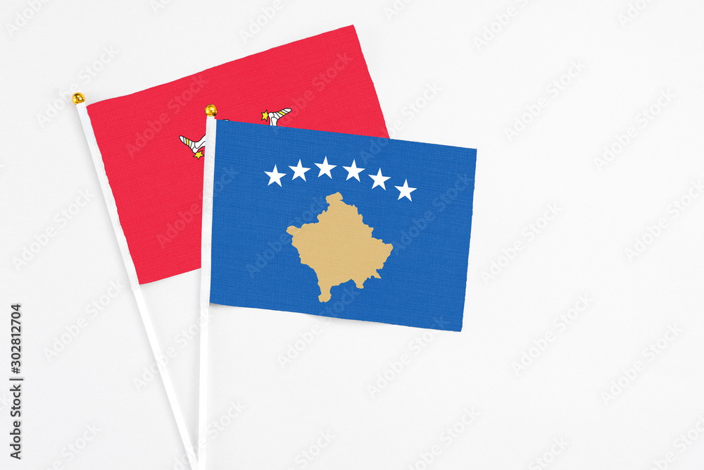 Kosovo and Isle Of Man stick flags on white background. High quality fabric, miniature national flag. Peaceful global concept.White floor for copy space. Kosovo and Isle Of Man stick flags on white background. High quality fabric, miniature national flag. Peaceful global concept.White floor for copy space.