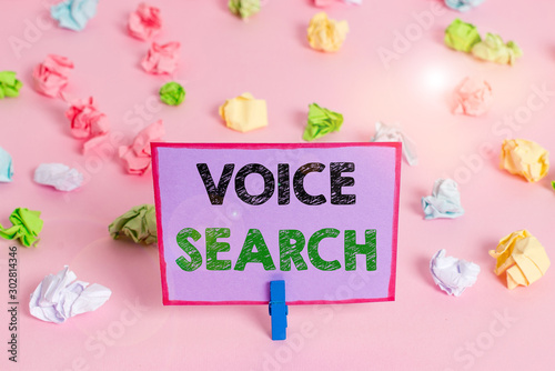 Writing note showing Voice Search. Business concept for allows the user to use a voice comanalysisd to search the Internet Colored crumpled papers empty reminder pink floor background clothespin © Artur