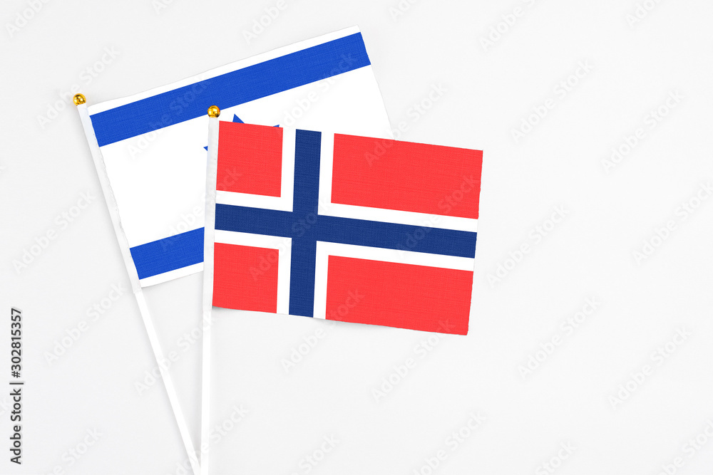 Bouvet Islands and Israel stick flags on white background. High quality fabric, miniature national flag. Peaceful global concept.White floor for copy space.