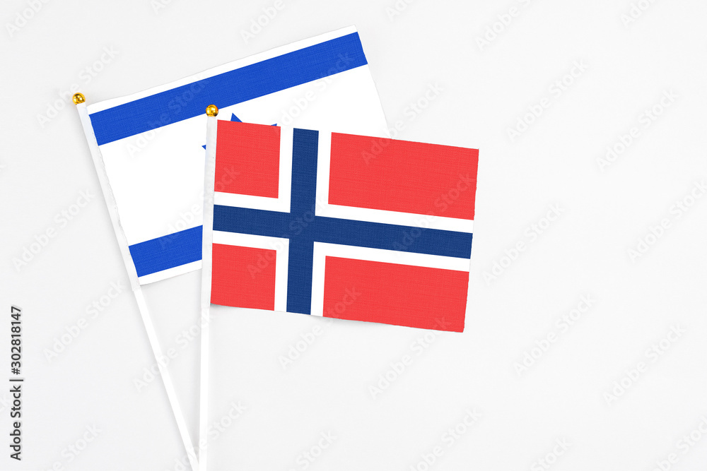 Norway and Israel stick flags on white background. High quality fabric, miniature national flag. Peaceful global concept.White floor for copy space.