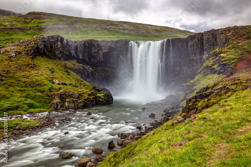 Gufufoss waterfall in the east fjords of Iceland. To reach the falls, it is just a short hike along the road down to very scenic town of Seydisfjordur.