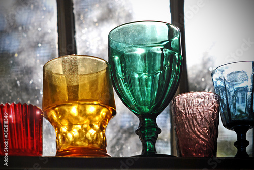 Collection of glassware sparkles in the window.