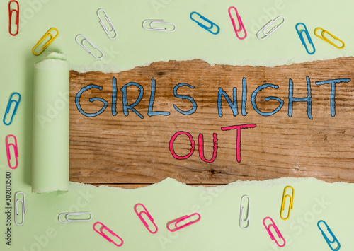 Writing note showing Girls Night Out. Business concept for Freedoms and free mentality to the girls in modern era Paper clip and torn cardboard on wood classic table backdrop photo