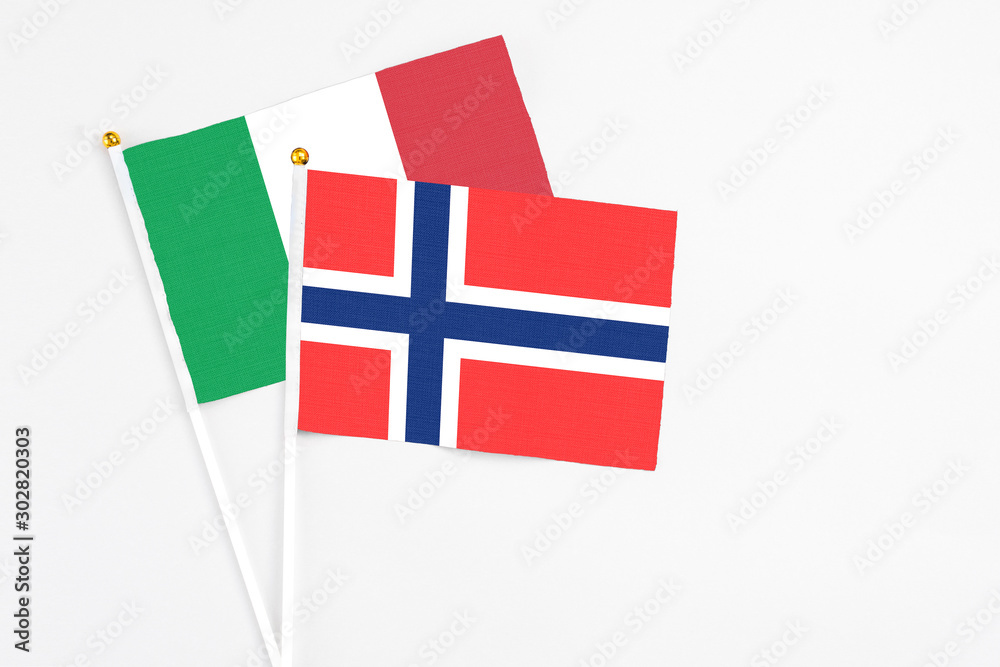 Bouvet Islands and Italy stick flags on white background. High quality fabric, miniature national flag. Peaceful global concept.White floor for copy space.