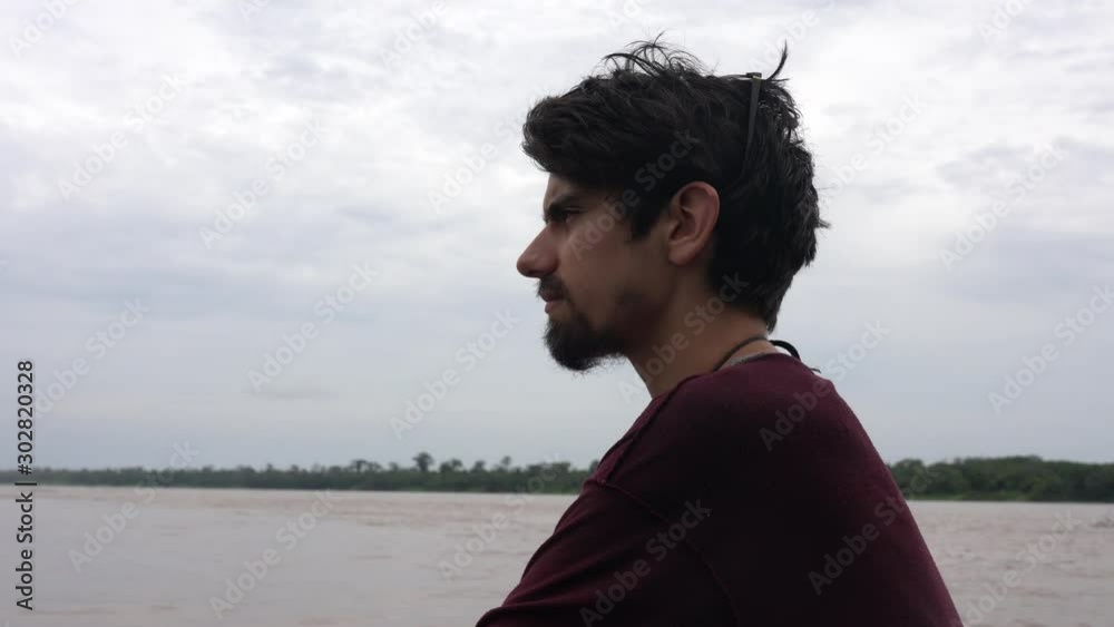 Close up shot of a white male Caucasian traveler's face on a boat on Amazon river in rainforest, Brazil Close up shot of a white male Caucasian traveler's face on a boat on Amazon river in rainforest, Brazil