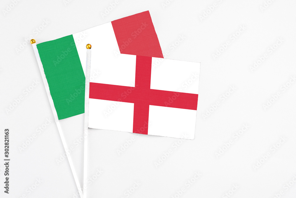 England and Italy stick flags on white background. High quality fabric, miniature national flag. Peaceful global concept.White floor for copy space.