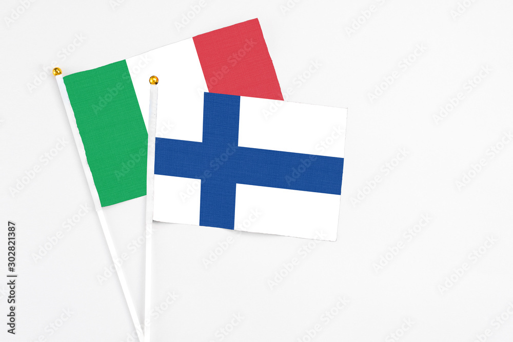 Finland and Italy stick flags on white background. High quality fabric, miniature national flag. Peaceful global concept.White floor for copy space.