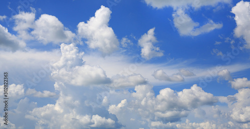 Blue sky and fluffy clouds background.