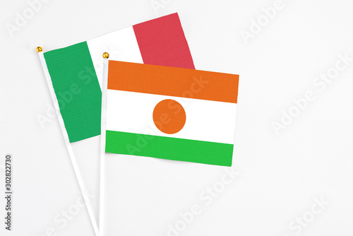 Free Download Niger and Italy stick flags on white background. High quality fabric, miniature national flag. Peaceful global concept.White floor for copy space. - GFXLoad