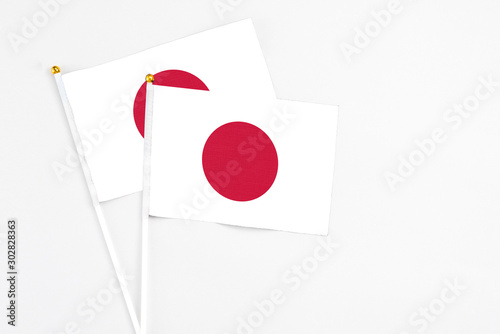 Japan and Japan stick flags on white background. High quality fabric, miniature national flag. Peaceful global concept.White floor for copy space. Free Download Japan and Japan stick flags on white background. High quality fabric, miniature national flag. Peaceful global concept.White floor for copy space. - GFXLoad