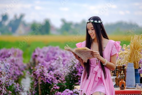 portrait beautiful woman in flower garden background photo