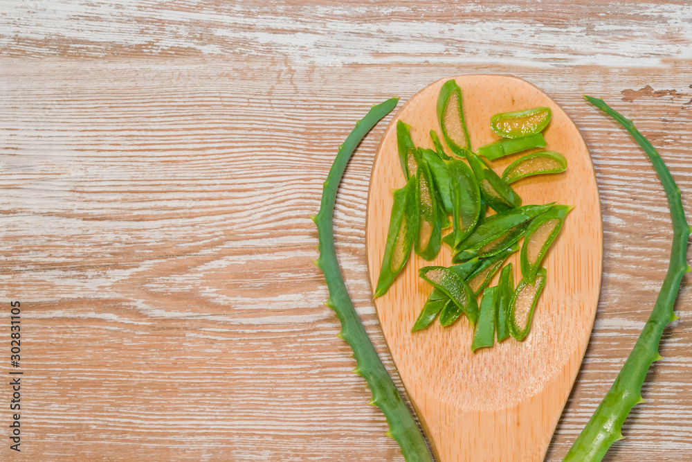 in a wooden spoon on a wooden background. The concept of health, treatment, herbal medicine, skin care,spa .Top view. Flat lay.