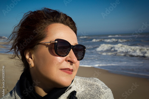 Portrait of a woman on the sea sandy beach photo