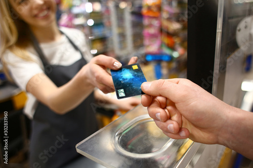 Young man paying for goods ...