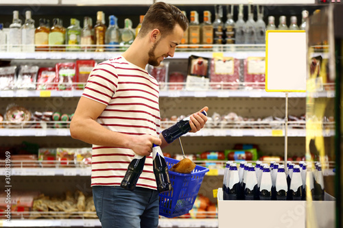 Young man choosing food in ...